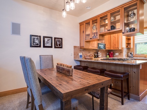 Gather around the rustic dining table for meals and conversation, with a fully-equipped kitchen right at your fingertips for easy meal prep and entertaining.
