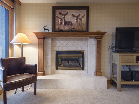 Curl up in your plush leather chair by the cozy fireplace while enjoying mountain views through the window. A warm, inviting space perfect for relaxing evenings with your favorite shows on the flat-screen TV.