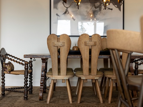 Gather around this inviting rustic dining table where your group can share meals and stories. Warm wood tones and unique artisan chairs create a charming, cozy atmosphere for memorable dinners together.