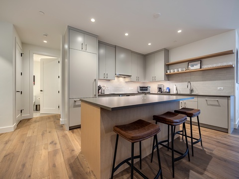 Your sleek, modern kitchen offers everything you need to whip up meals during your stay—complete with a spacious island and bar seating for easy, casual dining.