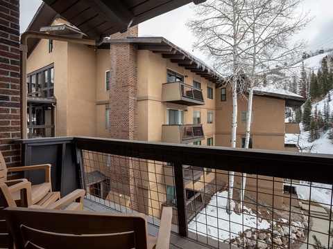 Private balcony overlooking snow-dusted mountains and aspen trees, with comfortable seating for your morning coffee or evening relaxation in the crisp mountain air.