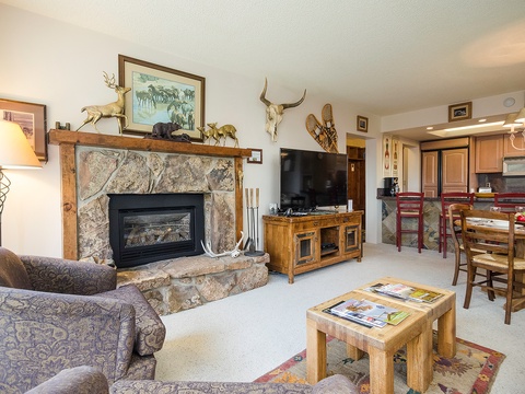 Unwind in your cozy retreat with rustic charm—a crackling stone fireplace, comfortable seating, and a fully-equipped kitchen, all adorned with Western-inspired decor that makes you feel right at home.
