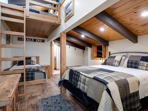 Sink into soft, plaid-covered beds under warm timber beams. The bunk bed adds extra sleeping space, perfect for families or groups.
