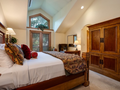 Sink into crisp white linens and wake to natural light streaming through arched windows. Warm wood furnishings and vaulted ceilings create your peaceful mountain retreat.