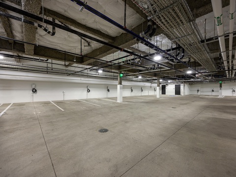 A spacious underground parking garage with marked spaces and modern infrastructure ensures convenient vehicle storage during your stay.