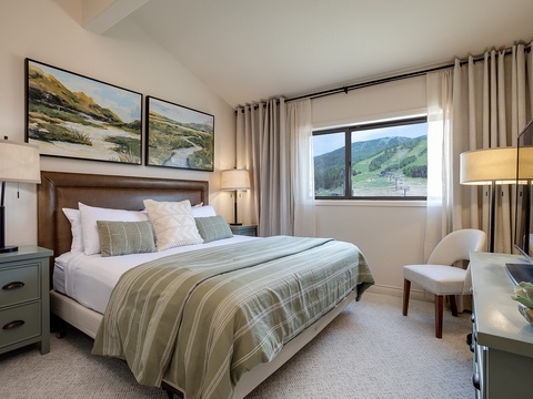 Wake up to stunning mountain vistas framed by soft linens and elegant decor. Your peaceful retreat offers cozy seating and serene views to unwind after a day of adventure.