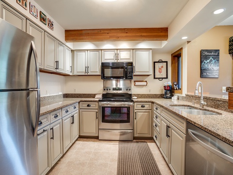 Your fully equipped kitchen features granite counters, stainless appliances, and ample space to prepare mountain meals together. Rustic wood beams and thoughtful décor create a welcoming heart of your retreat.
