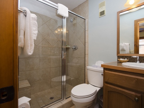 Freshen up in your private bathroom, complete with a glass-enclosed shower, granite vanity, and plush towels ready for you.