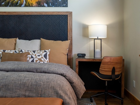 Sink into this plush bed after your adventures—crisp linens, soft pillows, and a cozy workspace await you in your peaceful retreat.