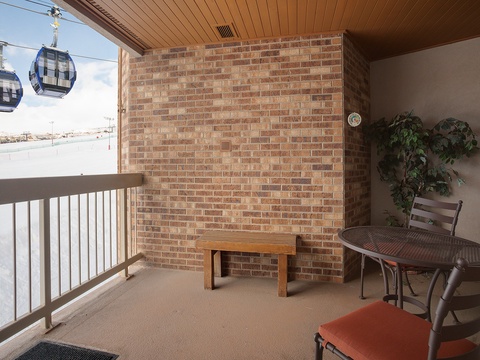 Step onto your private balcony with ski-lift views—perfect for morning coffee or unwinding after a day on the slopes with your small dining setup and cozy seating.