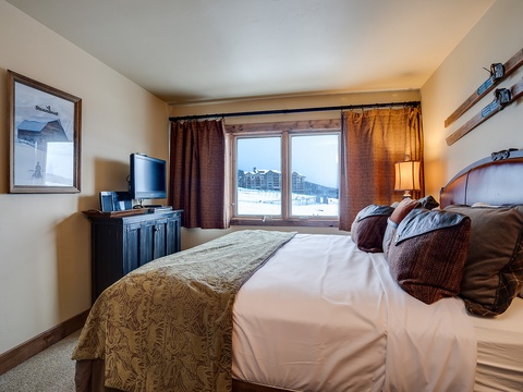 Wake up to stunning mountain views from your cozy bedroom, where rustic charm meets modern comfort. Plush bedding and warm wood accents create the perfect retreat after a day of adventure.