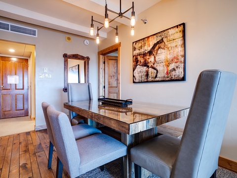 Gather around this stunning rustic table where warm wood tones and elegant artwork create the perfect setting for your morning coffee or evening meals together.