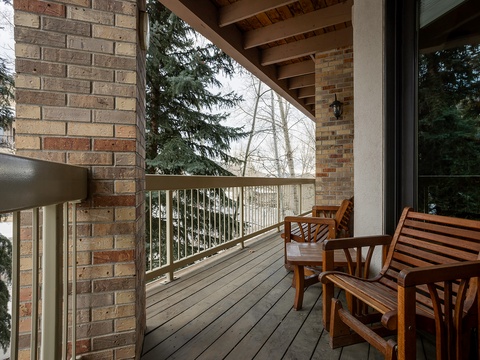 Step onto your private balcony and breathe in the fresh air. Wooden chairs invite you to relax with morning coffee or unwind as the trees sway beyond the railing.