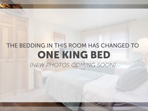 Your bright, spacious bedroom features crisp white linens, warm wood accents, and a peaceful ambiance perfect for unwinding after mountain adventures.