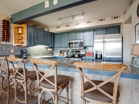 Your fully equipped kitchen invites you to gather around the island, where rustic charm meets modern convenience—perfect for morning coffee or prepping a family meal together.
