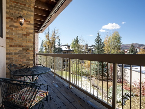 Private balcony overlooks a peaceful residential neighborhood with mountain views and autumn foliage—a perfect spot for morning coffee or evening relaxation.