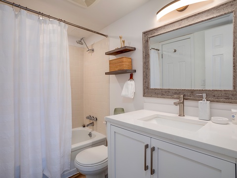 Step into your beautifully updated bathroom with a spacious vanity, relaxing shower-tub combo, and stylish touches that make freshening up feel like a mini spa retreat.