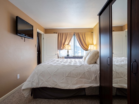 Sink into plush bedding and unwind in your serene bedroom retreat. Warm lighting and soft textures create a cozy haven where you'll drift off to sleep in total comfort.
