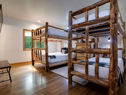 Rustic log-framed bunk beds fill your room with cozy mountain charm, creating a warm and inviting space for restful nights after adventure-filled days.