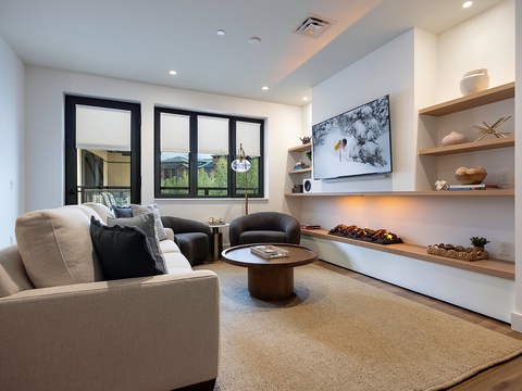 Sink into the plush seating and unwind in this thoughtfully designed living space, where natural light floods through large windows and modern built-ins create the perfect blend of comfort and style for your mountain getaway.