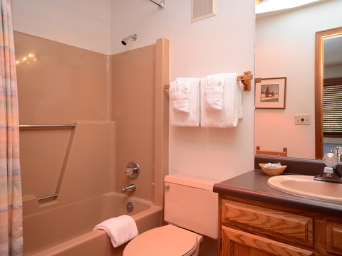 Your bathroom offers a clean, comfortable space with a tub-shower combo, fresh towels, and thoughtful touches like soft lighting to help you unwind after exploring.