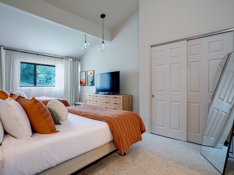 Wake up to mountain views framed by soft natural light in your serene bedroom retreat. Sink into plush bedding accented with warm burnt orange tones, unwind with your favorite shows, and enjoy the comfort of modern style blended with homey touches.