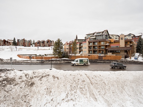 Ski resort community nestled in snowy mountain surroundings, featuring convenient parking and multiple lodging options for winter getaways.