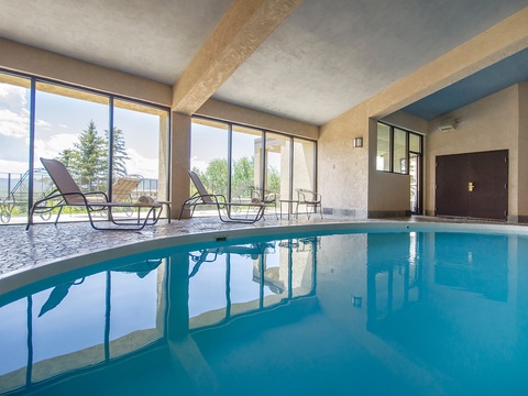 Slip into crystal-clear waters in your private indoor pool, where floor-to-ceiling windows frame stunning mountain vistas. Lounge poolside and let natural light wash over you as you unwind in complete tranquility.