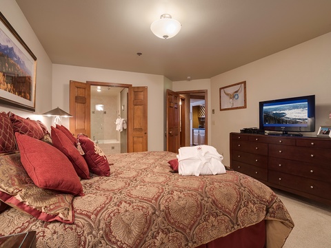 Sink into plush bedding and unwind in your private retreat, complete with a cozy en-suite bath and mountain views on the TV. Your perfect escape awaits.