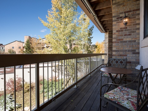 Picture yourself sipping morning coffee on your private balcony, surrounded by golden autumn foliage and fresh air. This cozy outdoor retreat offers peaceful neighborhood views and a perfect spot to unwind after exploring.