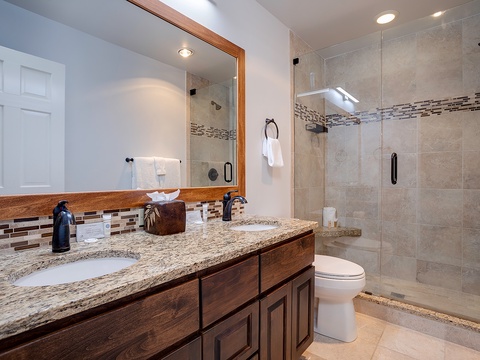 Step into your private spa-like bathroom featuring granite counters, elegant tiling, and a spacious walk-in shower—everything you need to refresh and recharge during your stay.