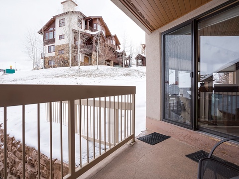 Charming alpine village setting surrounds your private balcony, perfect for morning coffee with snow-dusted mountain views and fresh winter air.