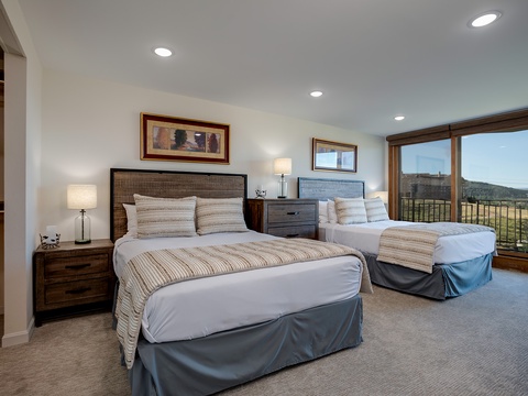 Drift off with serene mountain views framing your window, where plush bedding and tasteful decor invite you to unwind in restful comfort.