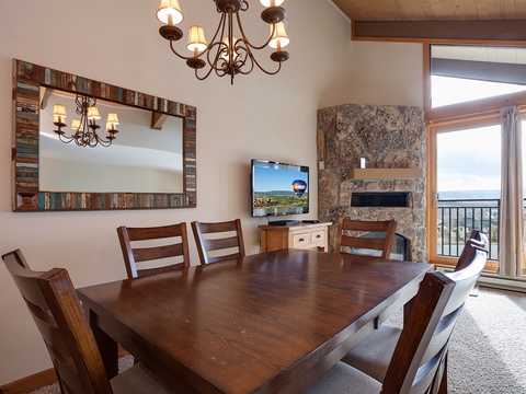 Your dining space with warm wood tones and rustic charm opens to a private balcony with sweeping views—perfect for leisurely meals as you take in the natural beauty beyond.