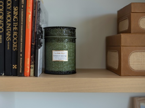 Find everything you need on your private shelf—books to browse, a calming candle, and storage boxes to keep your space tidy and serene.