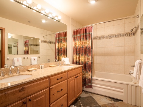 Your private bathroom features a spacious double vanity, relaxing soaking tub, and walk-in shower—perfect for unwinding after a day of adventure.