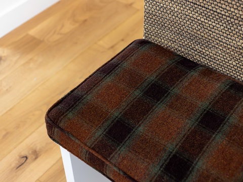 Cozy plaid accents and warm wood floors invite you to settle in and feel right at home during your stay.