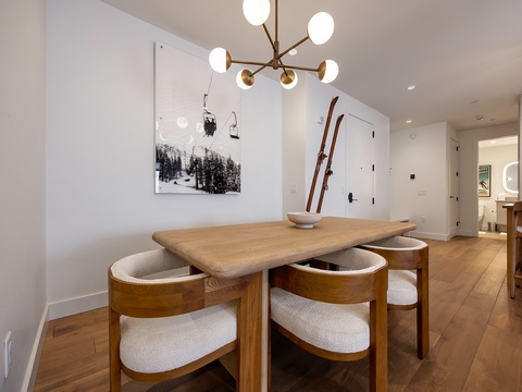 Gather around this stylish dining space where vintage skis and modern elegance meet, creating the perfect spot for sharing meals and mountain memories with your group.