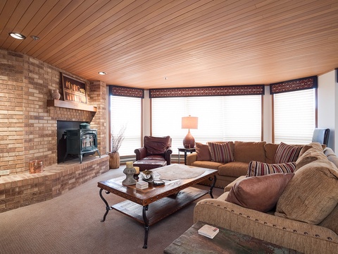Sink into the plush sofa by the glowing fireplace and let mountain light fill this warm living space. Perfect for relaxing after a day of adventure.