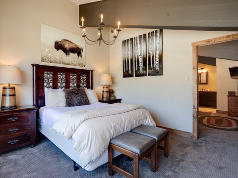 Sink into crisp white linens and rustic elegance in this welcoming bedroom, where warm wood accents and thoughtful décor invite you to unwind after a day of adventure.