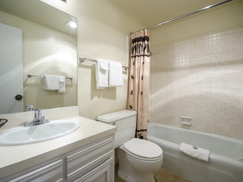 Your private bathroom features a full tub-shower combo, fresh towels, and all the essentials you need to unwind after a day of adventure.