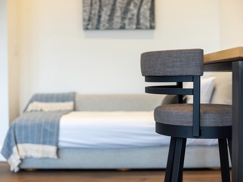 Your cozy bedroom retreat awaits with soft linens, a modern workspace, and thoughtful design touches to help you settle in and unwind after each adventure.