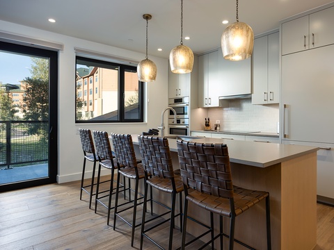 Gather with friends at your sleek kitchen island, where modern design meets comfort. Stunning pendant lighting sets the mood as you enjoy bright, airy spaces flooded with natural light from generous windows and easy balcony access.