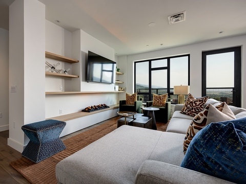 Sink into plush seating and soak up sweeping views through floor-to-ceiling windows in your bright, modern living space—perfect for morning coffee or evening wind-down.