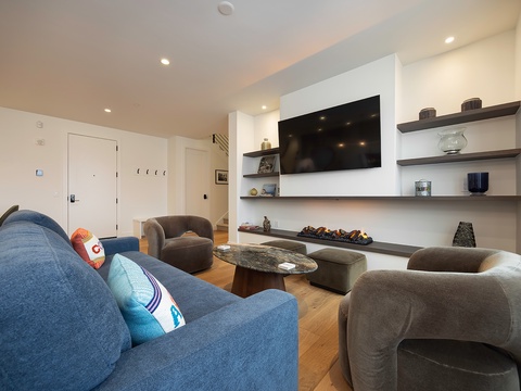 Settle into your stylish living space, where plush seating and warm hardwood floors create the perfect spot to unwind after a day of exploring.