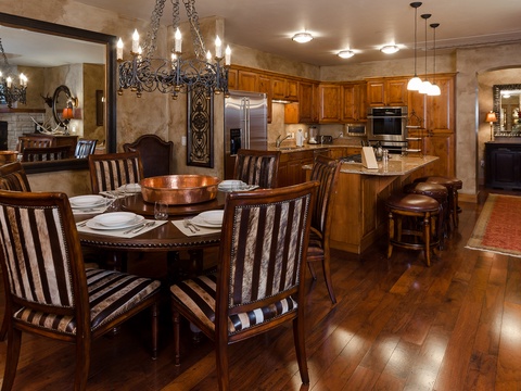 Your elegant dining space and fully equipped kitchen invite memorable meals together. Warm wood tones, custom cabinetry, and gleaming appliances blend comfort with style—your home away from home.