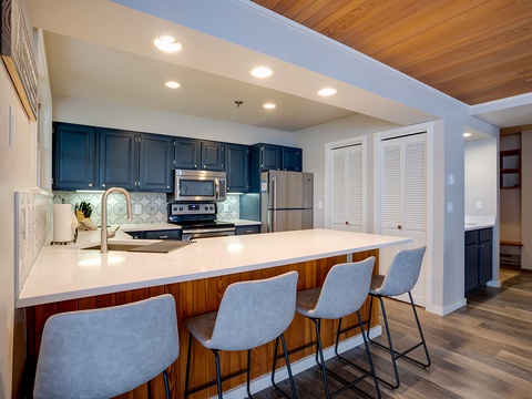 Your fully equipped kitchen features modern appliances, elegant countertops, and a breakfast bar where you can enjoy morning coffee or prepare memorable meals together.