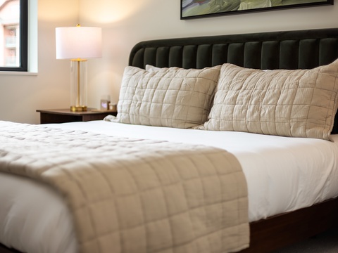 Sink into plush bedding and let the soft glow of natural light ease you into relaxation. Your restful retreat awaits.