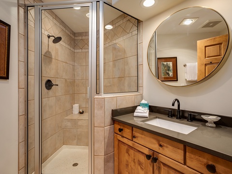 Step into your spa-like bathroom where warm earth tones and elegant tilework create a soothing retreat. Refresh in the spacious walk-in shower, then unwind at the stylish vanity surrounded by thoughtful details.
