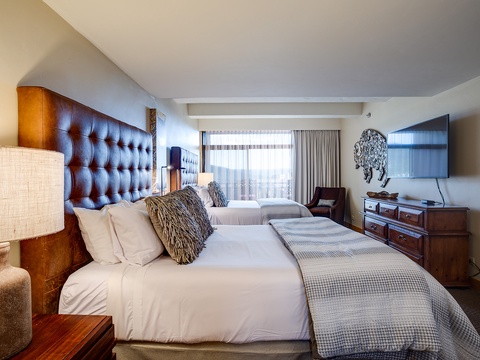 Settle into crisp linens and luxurious tufted headboards as natural light pours through your suite—perfect for unwinding after exploring the area.